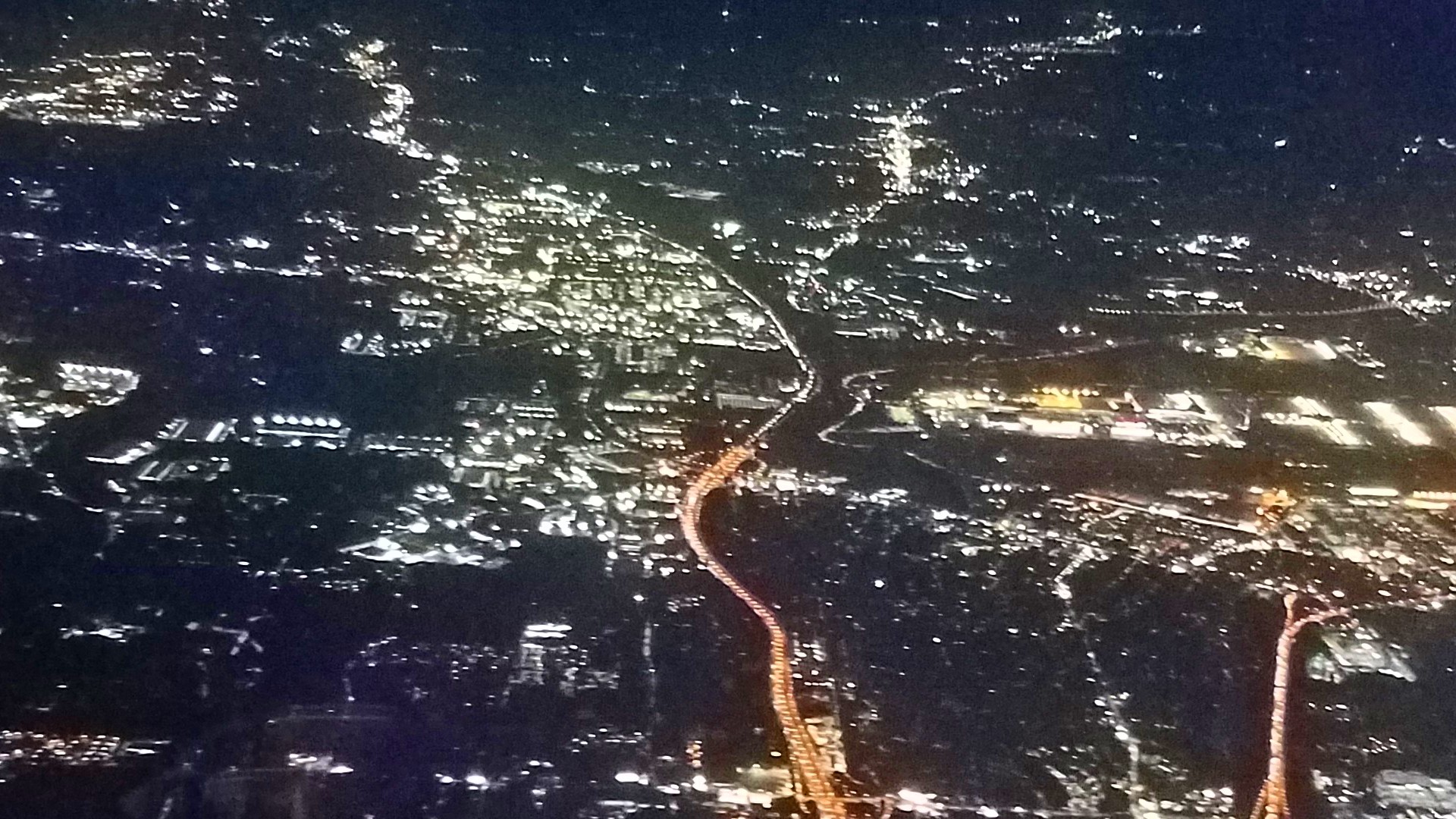 a mid air shot of atlanta at night, taken from a plane window