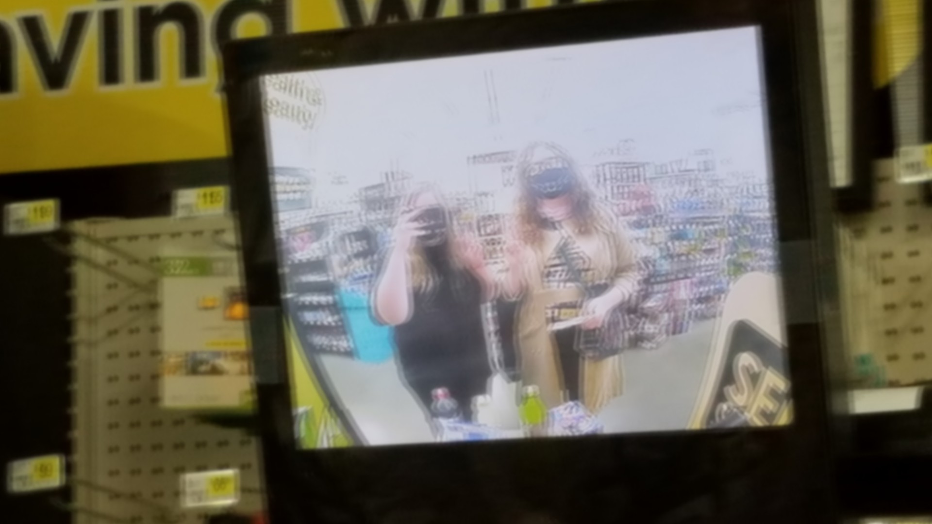 two girls with face masks in a dollar general getting some late night snacks